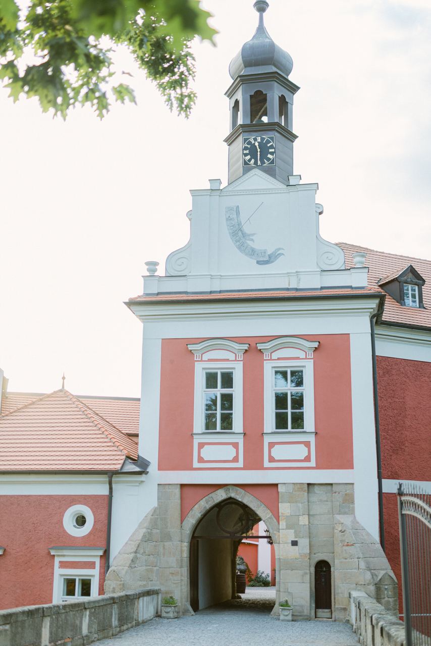 Savoia Castle, Škvorec, Czech Republic: castle gatehouse with a clock tower and a red-and-white façade